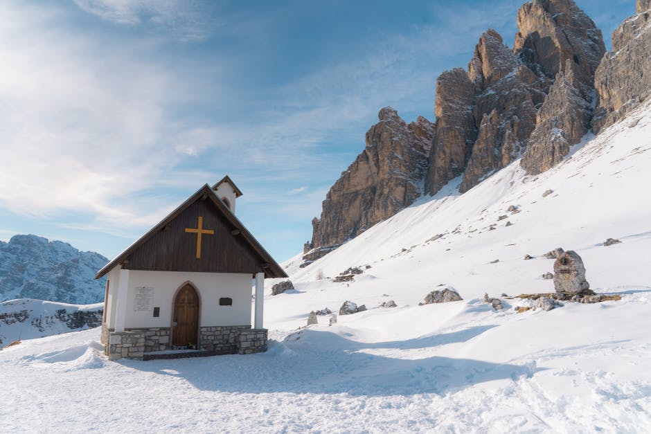 A serene chapel against snowy peaks
