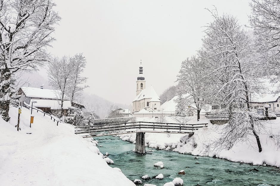 Snowy bridge over river with temple hill
